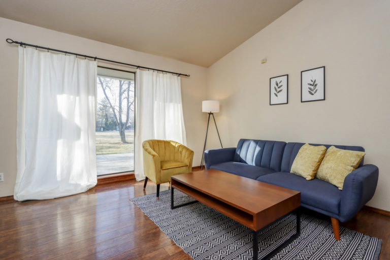 Living room with blue couch and yellow chair