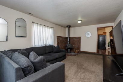 cozy living room with furnace grey couch and shag carpets